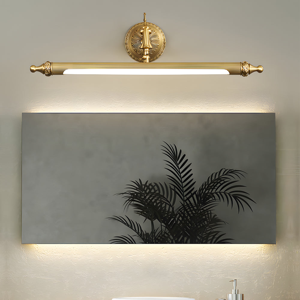 Brushed gold vanity light bar installed over a rectangular bathroom mirror