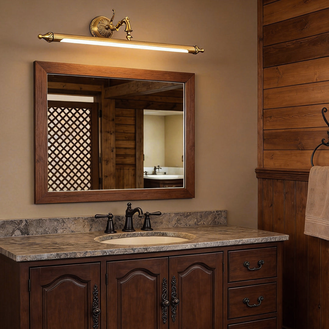Brushed gold vanity light bar mounted above a rustic bathroom mirror
