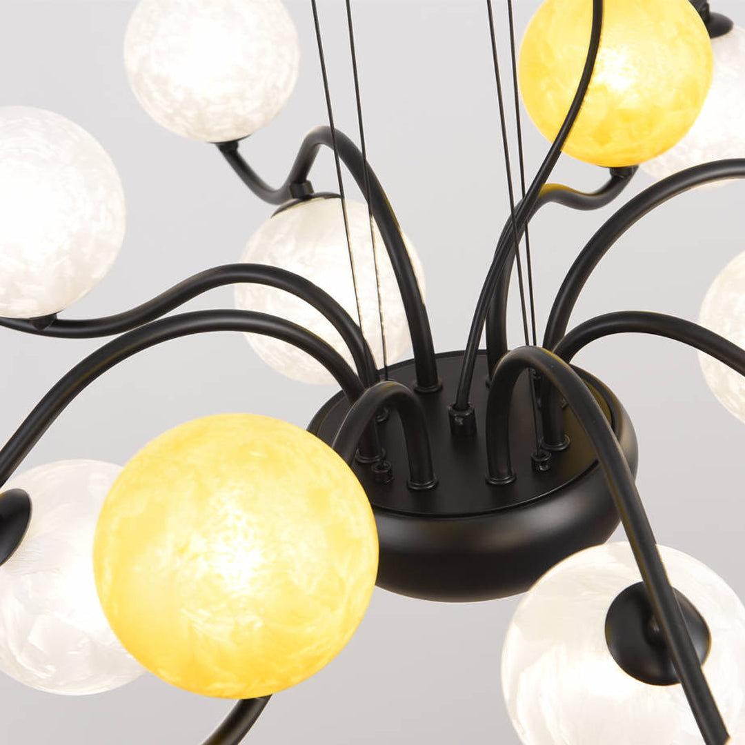Close-up of bubble chandelier showing textured and smooth glass globe shades with warm lighting.