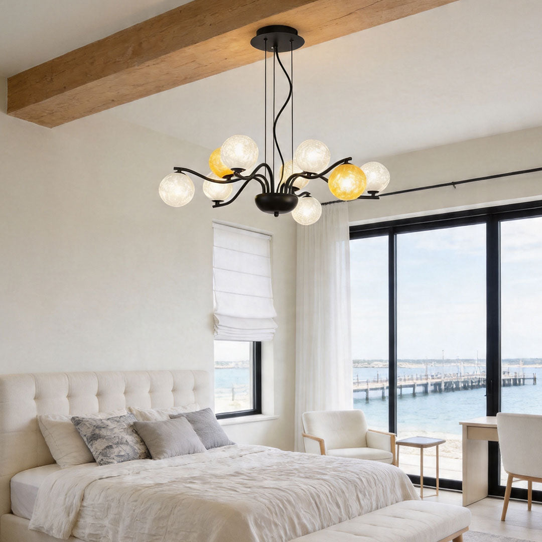 Black frame bubble chandelier with warm and clear glass globes in a contemporary living room with wood beam ceiling.