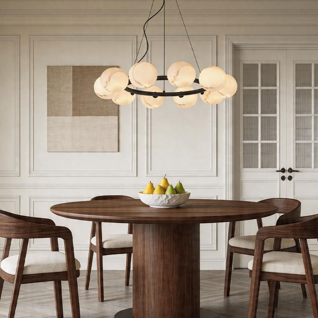 Elegant bubble glass chandelier above a round wooden dining table in a classic modern dining room.