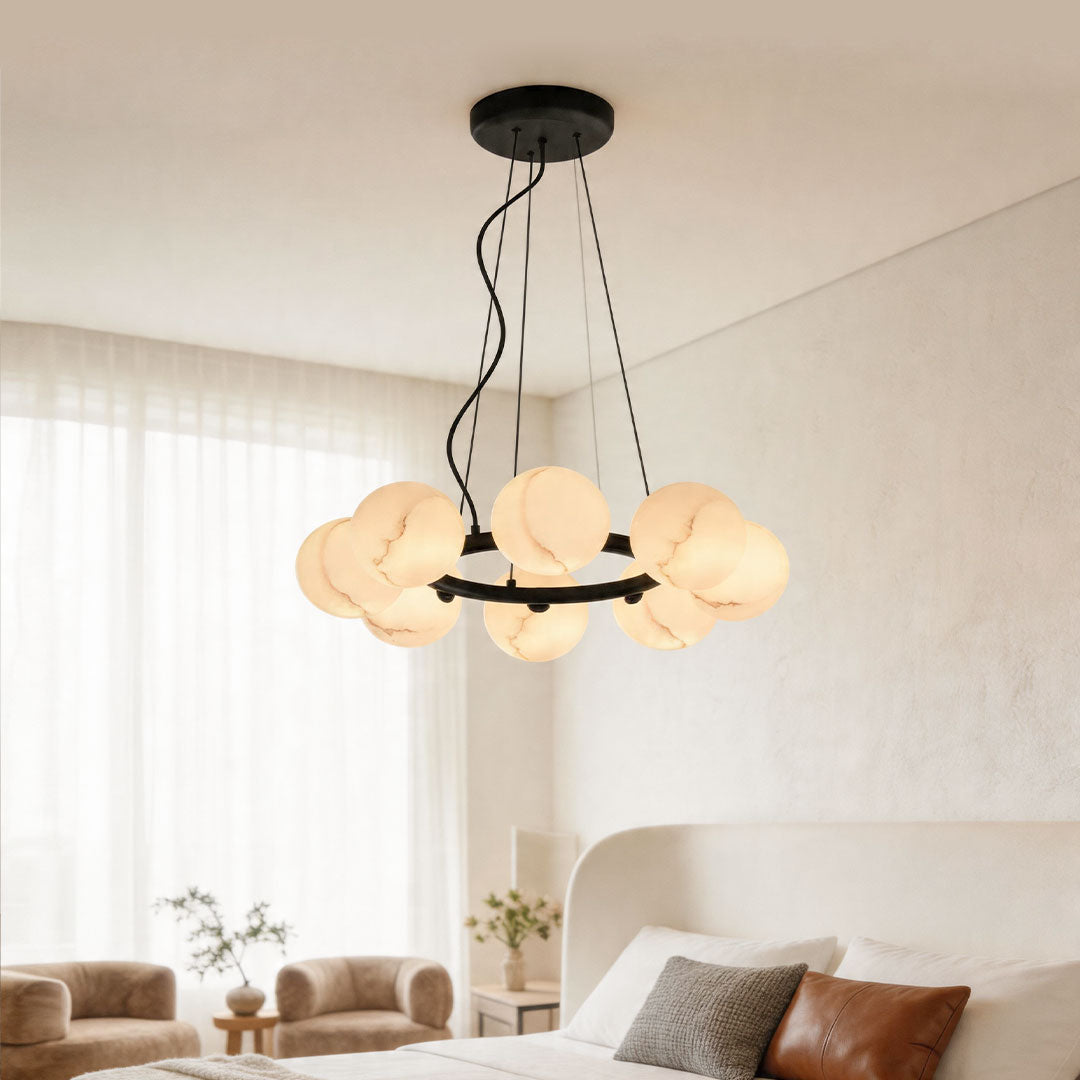 Modern bubble glass chandelier with multiple glowing globes hanging in a bright minimalist bedroom.