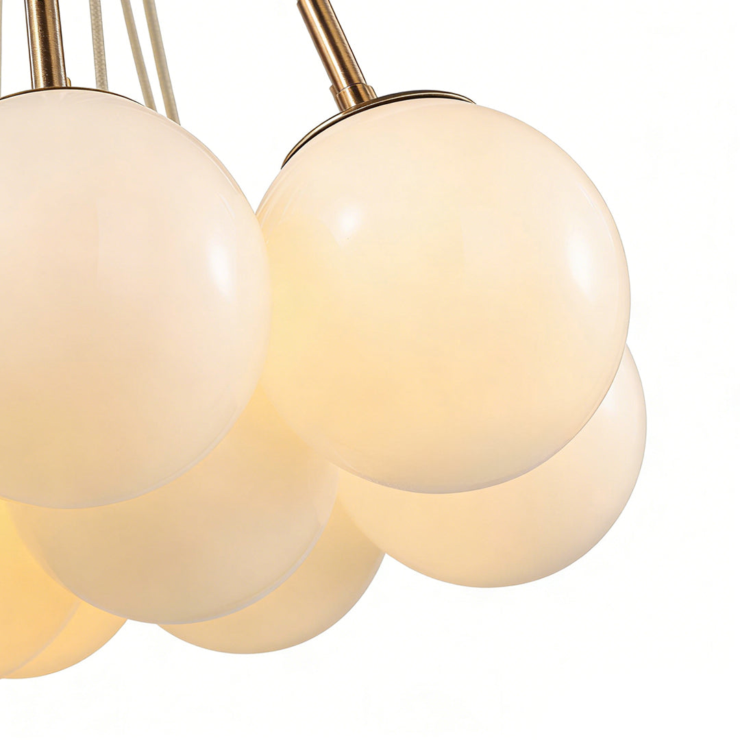 Stylish bubble glass chandelier featuring multiple spherical white glass shades with a modern, elegant design.