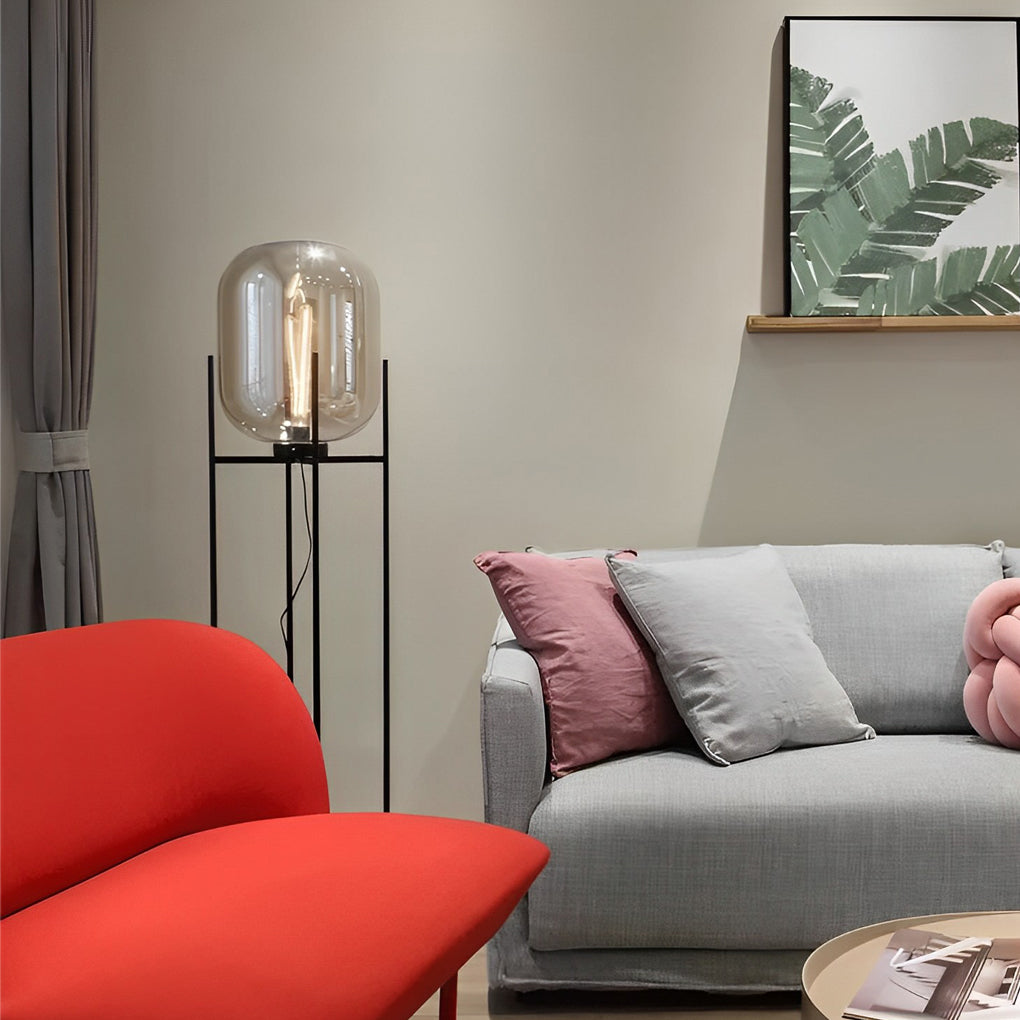 Bubble glass floor lamp with a tall black stand, illuminating a cozy corner with a red sofa.