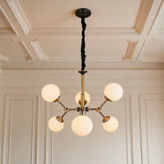 Bubble lighting chandeliers featuring frosted glass globe shades and a modern gold frame in a luxury room.