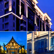 Commercial building facade illuminated by decorative wall wash lights.