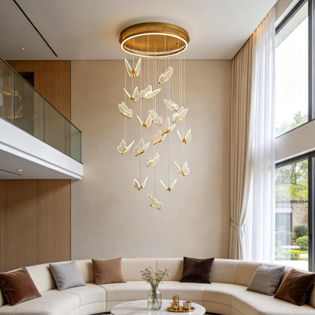 Modern butterfly chandelier installed in a double-height living room with cascading pendant design.