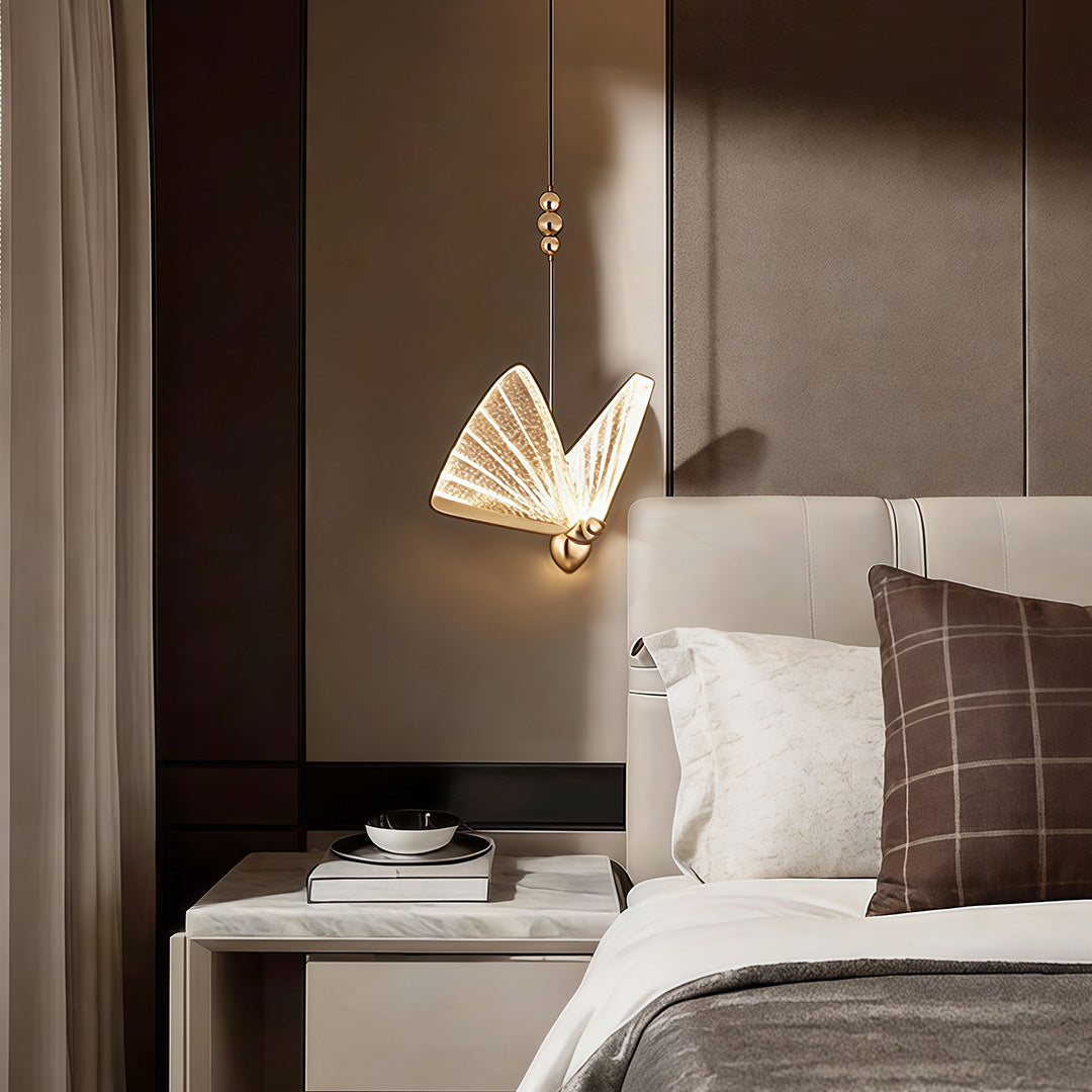 Butterfly pendant light installed beside bed creating soft ambient lighting in bedroom.
