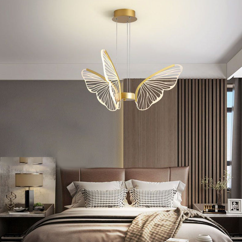 Butterfly pendant light casting a gentle glow in a contemporary bedroom.