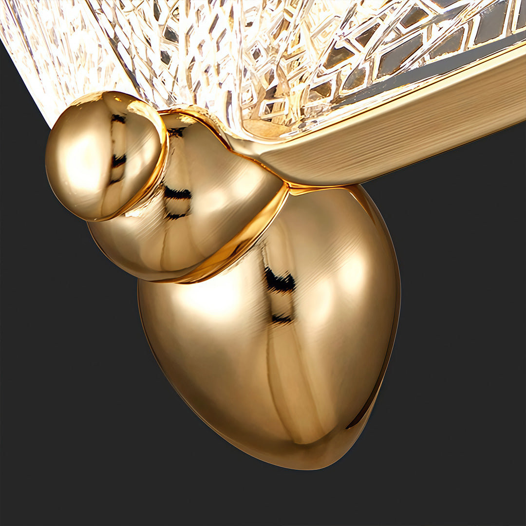 Close-up of butterfly pendant light gold metal body and hanging hardware detail.