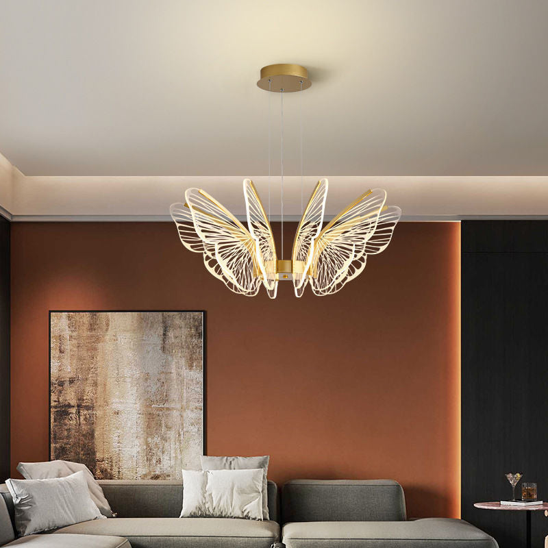 Butterfly pendant light providing warm light above a modern round table.