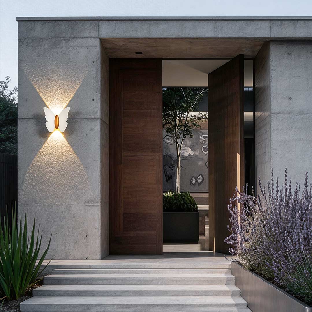 Butterfly wall lamp illuminating a modern house entrance with warm ambient glow.