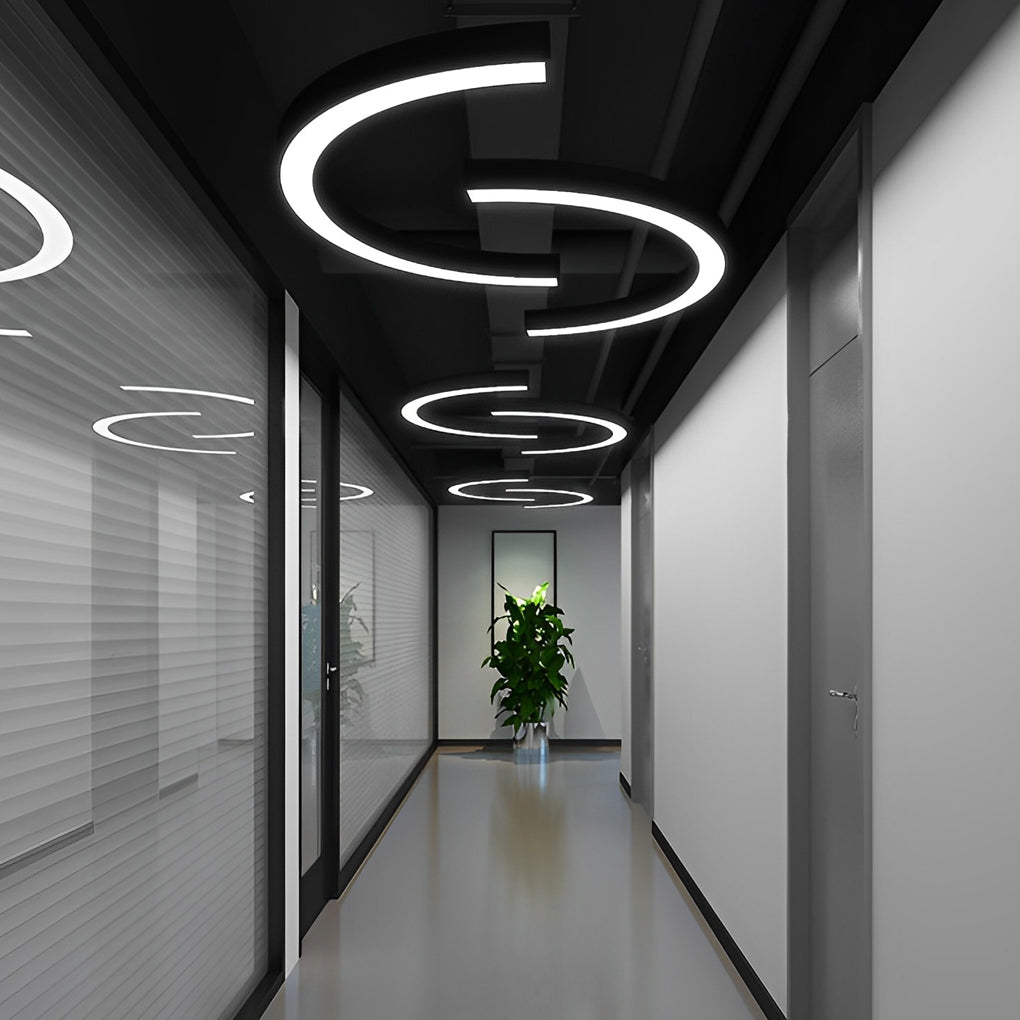 Modern C shape pendant light creating circular light patterns in contemporary hallway.