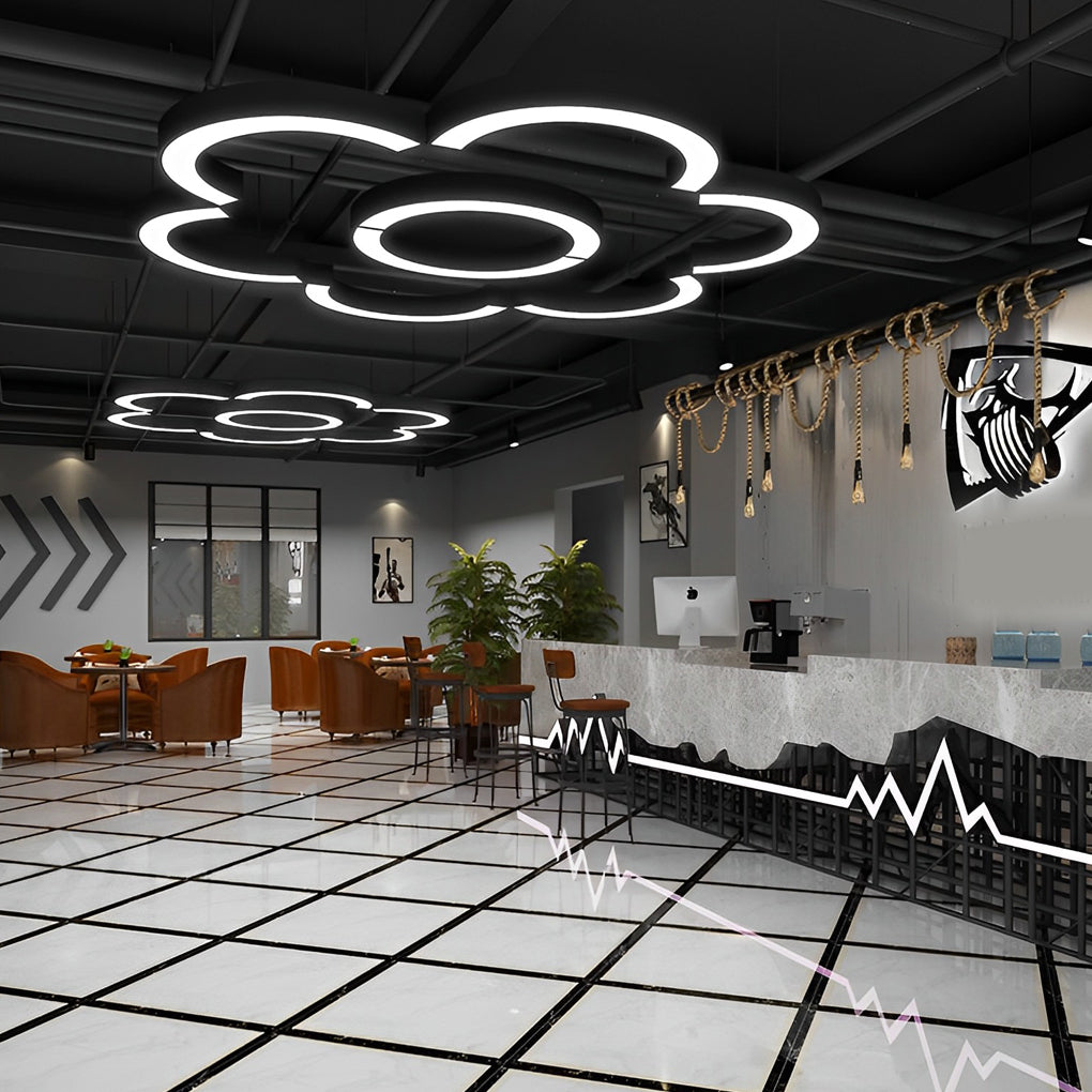 Modern C shape pendant light installed in creative workspace with geometric ceiling layout.