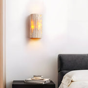 Modern bedroom featuring natural stone wall lights creating ambient lighting beside bed headboard