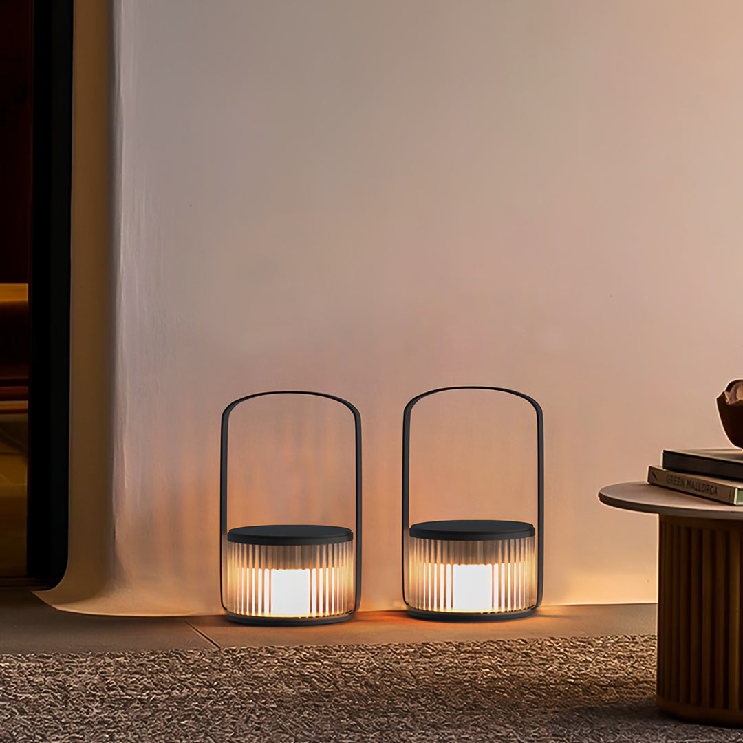 Two camping LED lanterns lighting up an indoor–outdoor transition area with soft ambient glow.