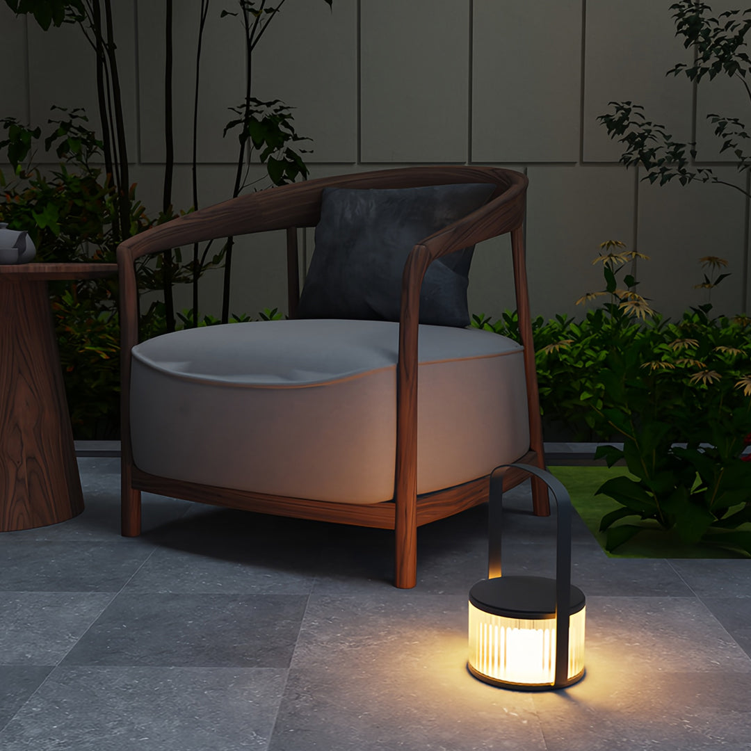 Camping LED lanterns placed beside outdoor seating, adding gentle illumination to a nighttime patio.