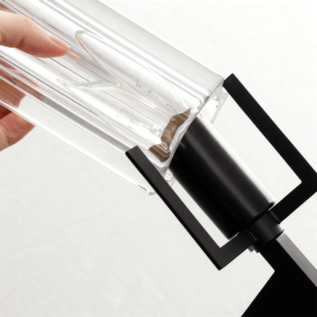 Candle chandeliers close-up detail showcasing matte black finish and clear fluted glass cylinder