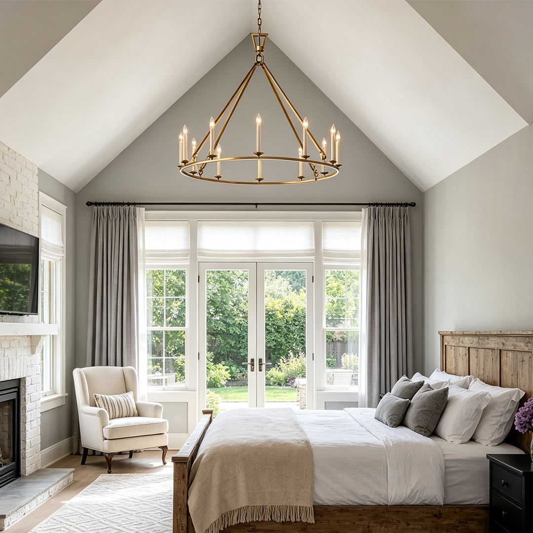 Candles chandelier hanging above a cozy bedroom with elegant farmhouse interior design.