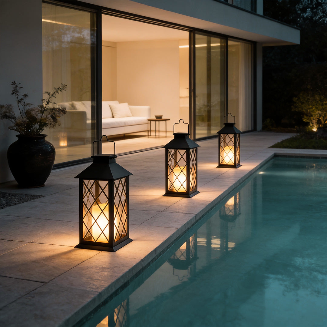 Candlestick lantern beside modern pool area with warm glow.