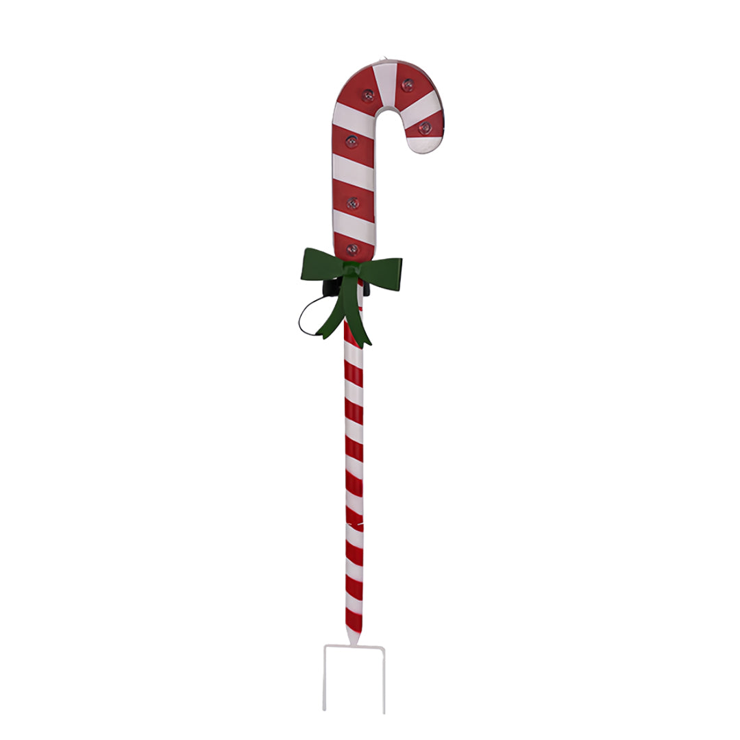 Candy cane ground stake for Christmas lights decorated with red stripes and a green holiday bow.