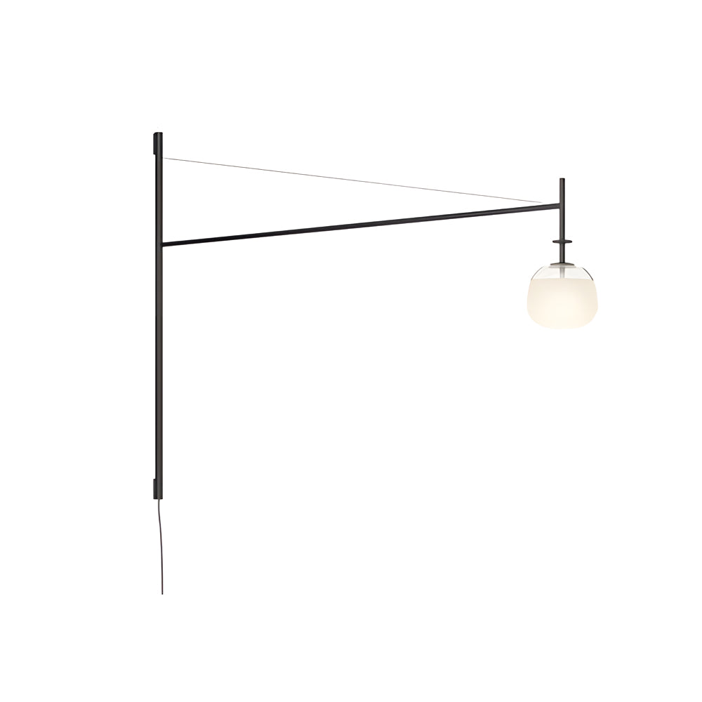 Cantilever wall lamp featuring a glass globe diffuser, isolated to highlight its balanced modern design.
