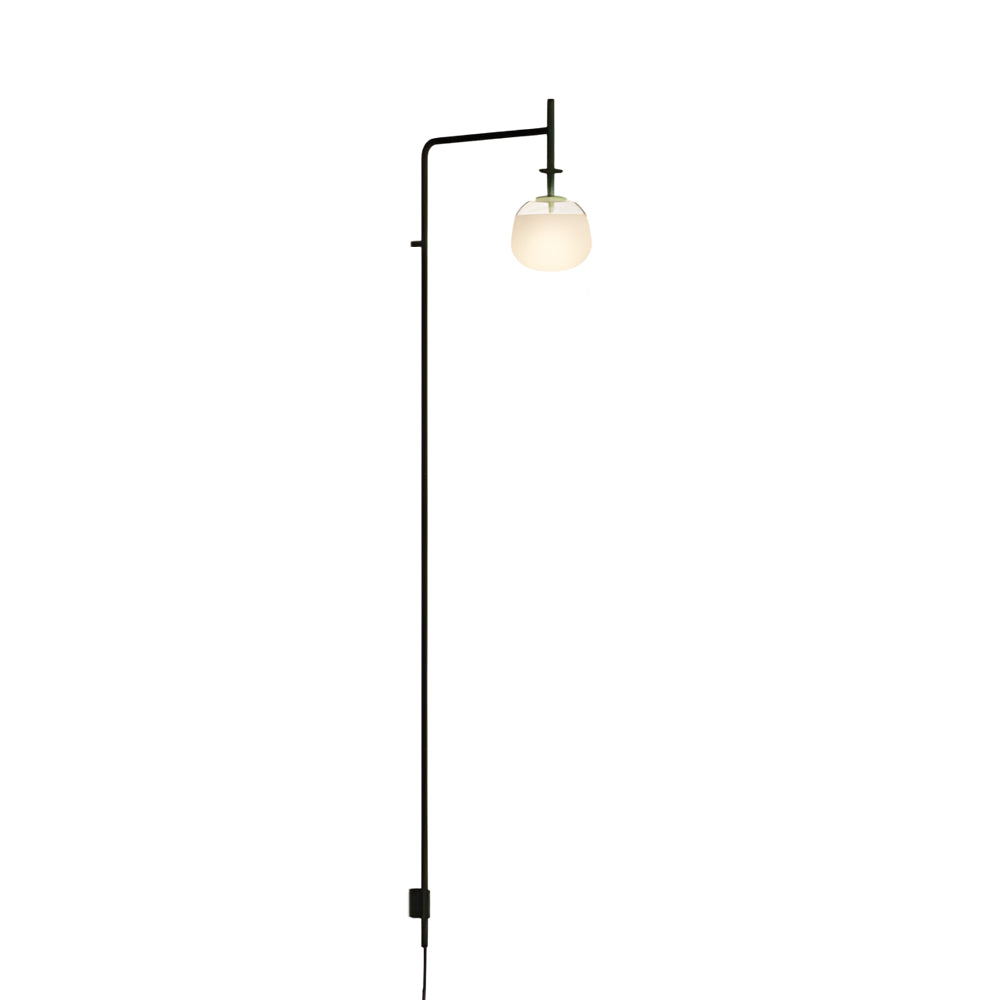 Modern cantilever wall lamp with round glass shade and slim profile, ideal for contemporary interiors.