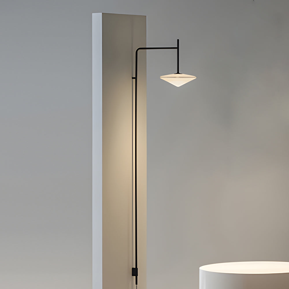 Slim vertical cantilever wall lamp mounted beside a column, delivering focused illumination with a modern aesthetic.