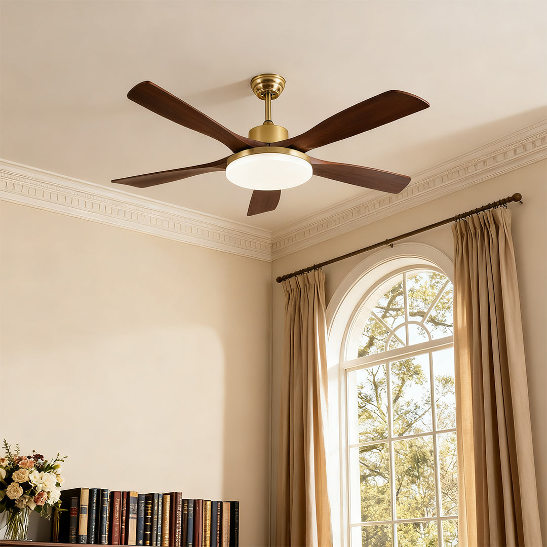 Ceiling fan with light and remote control, featuring wooden blades and a gold finish in a bright living space.