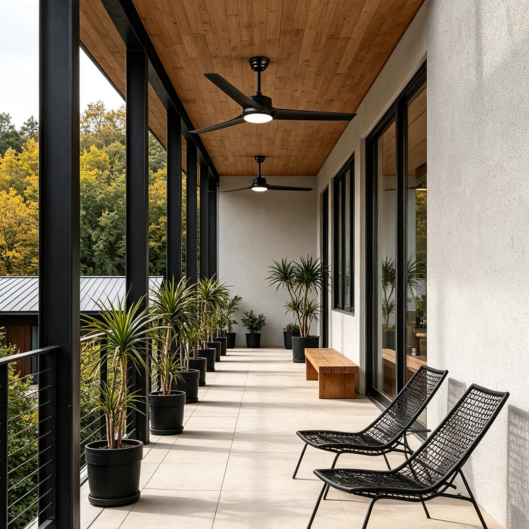 Ceiling fan with light mounted on a wood ceiling along a contemporary covered outdoor walkway.