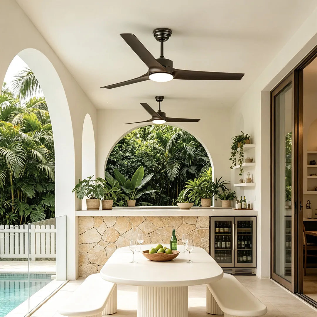 Ceiling fan with light above a covered outdoor dining area with arched openings and a pool view.