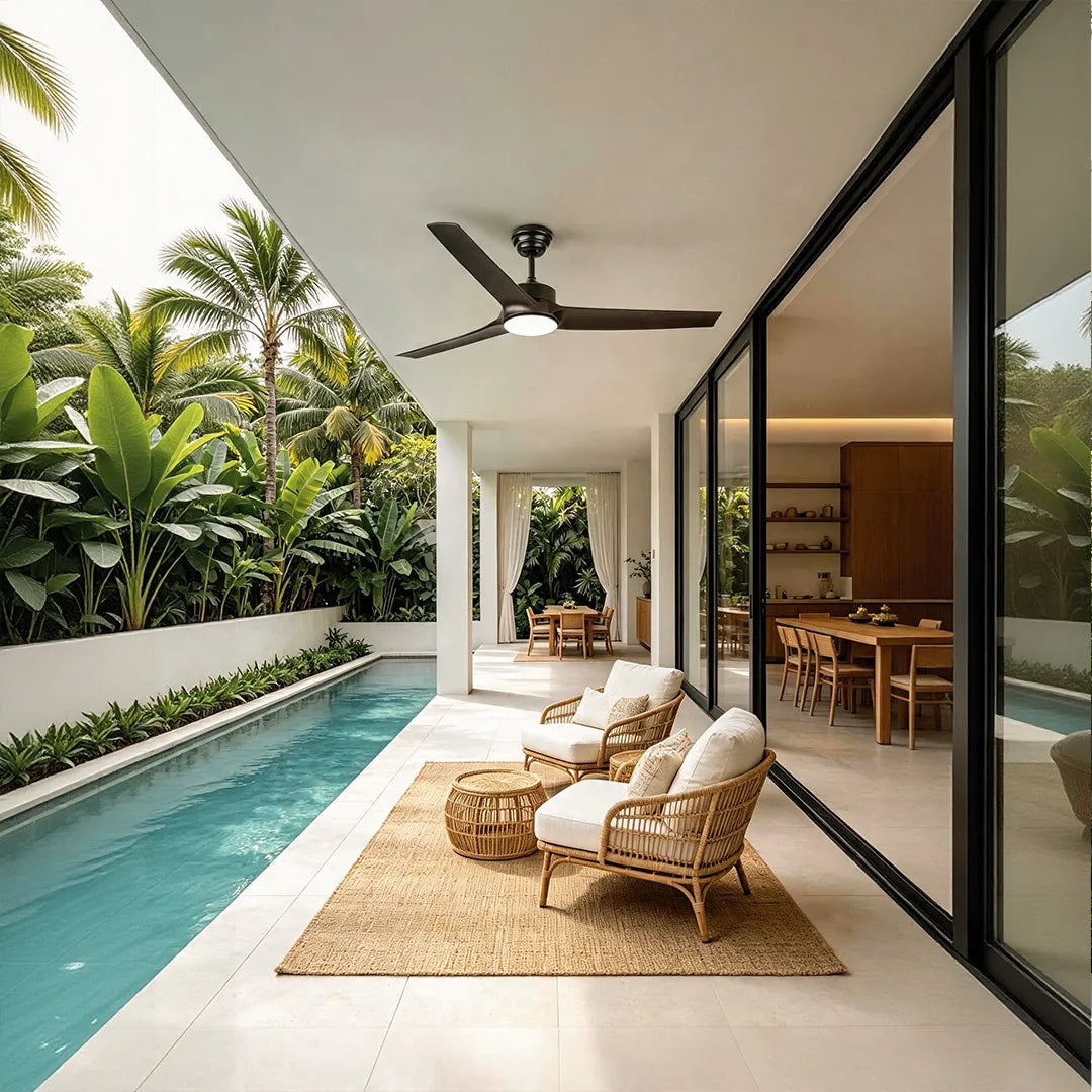Ceiling fan with light installed beside a swimming pool on a bright tropical outdoor terrace.
