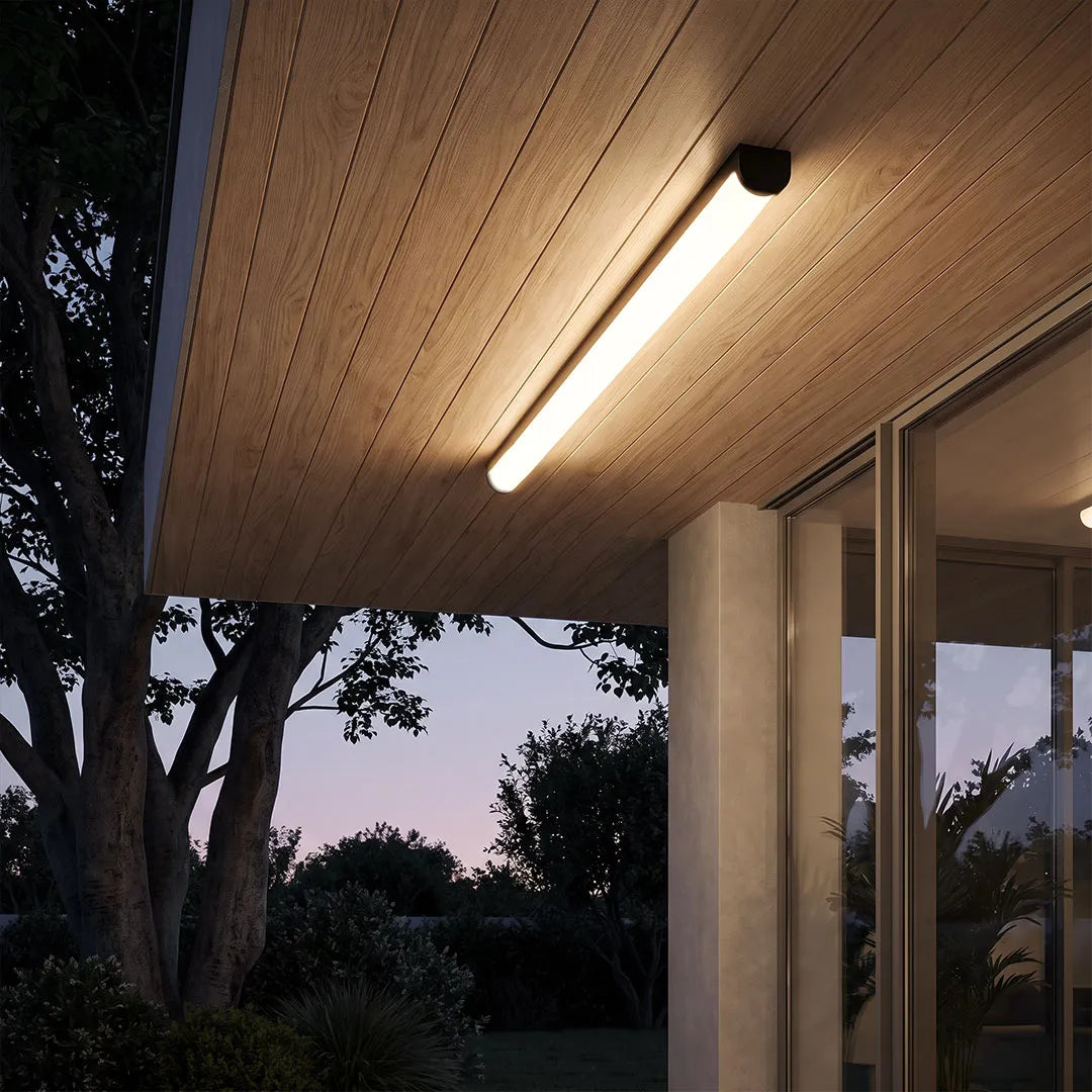 Ceiling linear light mounted on a wood-paneled porch ceiling, providing warm illumination at night.