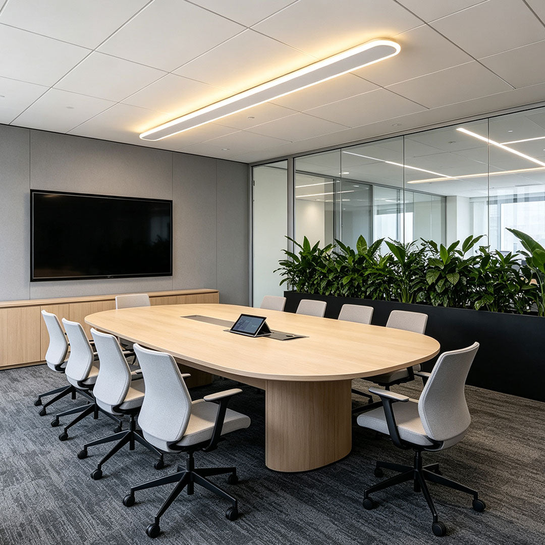 Modern ceiling linear lights installed above a conference table in a contemporary office meeting room.