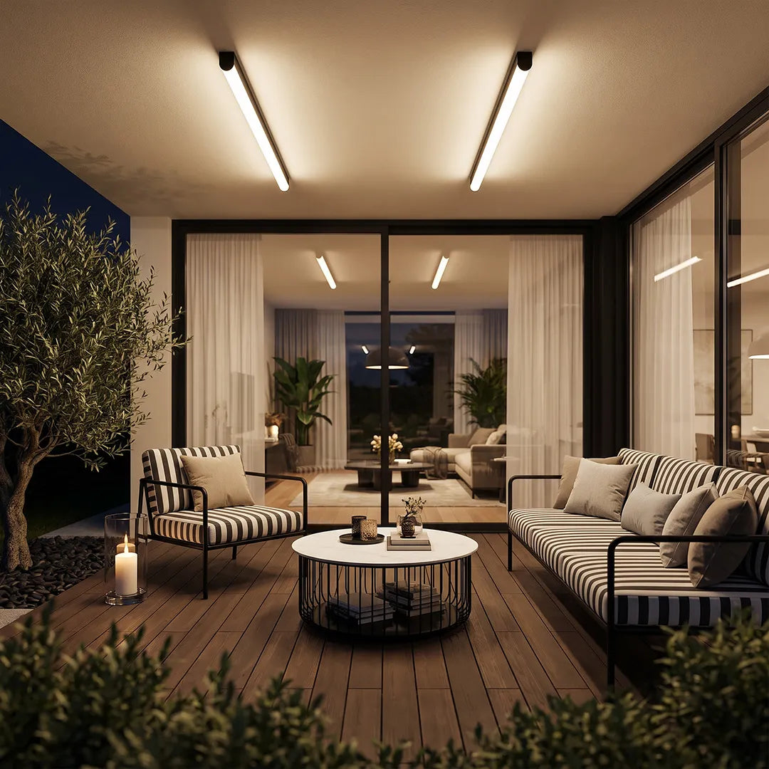 Ceiling linear lights installed above a contemporary outdoor lounge with striped seating at night.