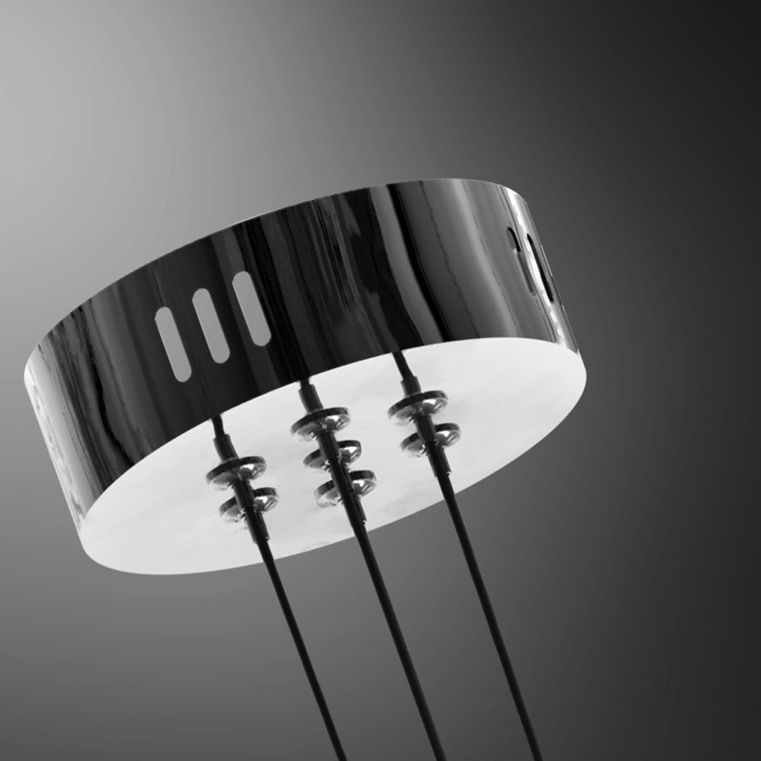 Detailed view of modern LED chandelier showing black ceiling mount and multiple crystal glass shade connections