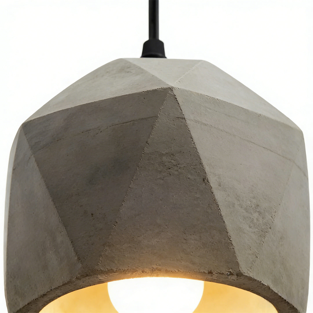 Cement look pendant lights enhancing a stylish dining table with ambient light.