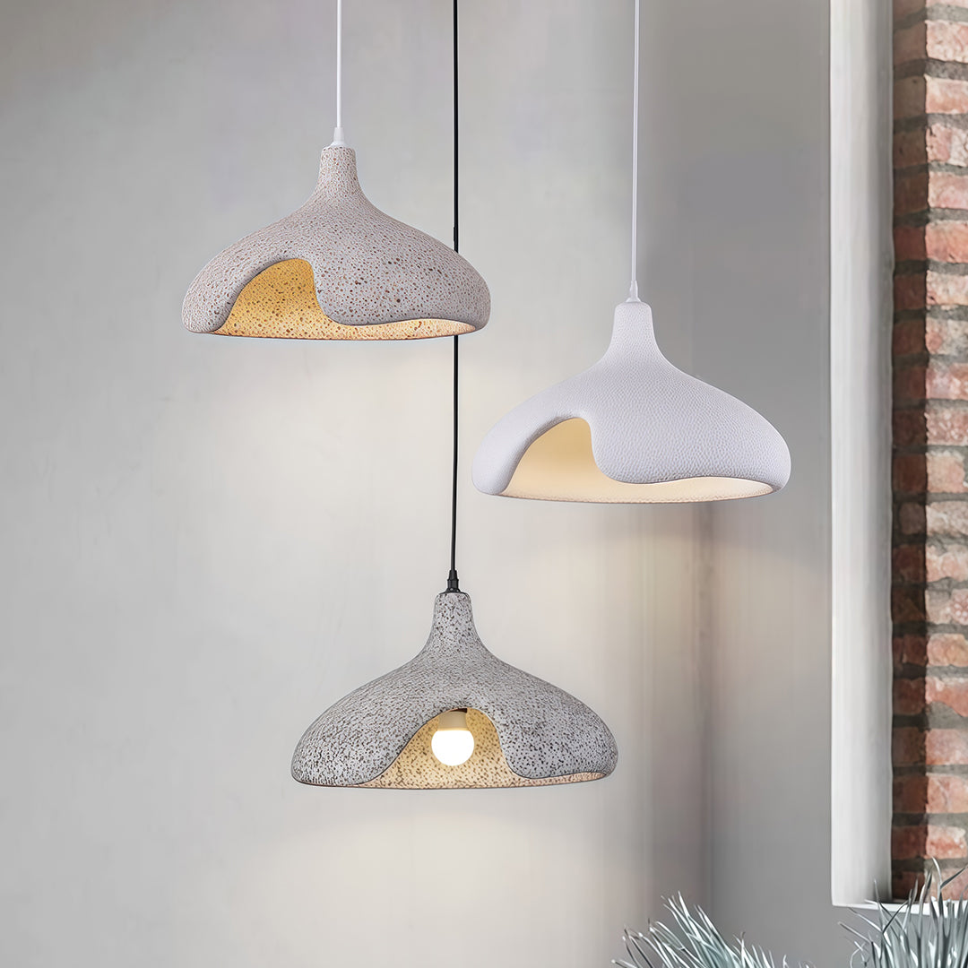 Set of Cement Pendant Lights in gray and white, mounted on concrete wall for modern industrial style.