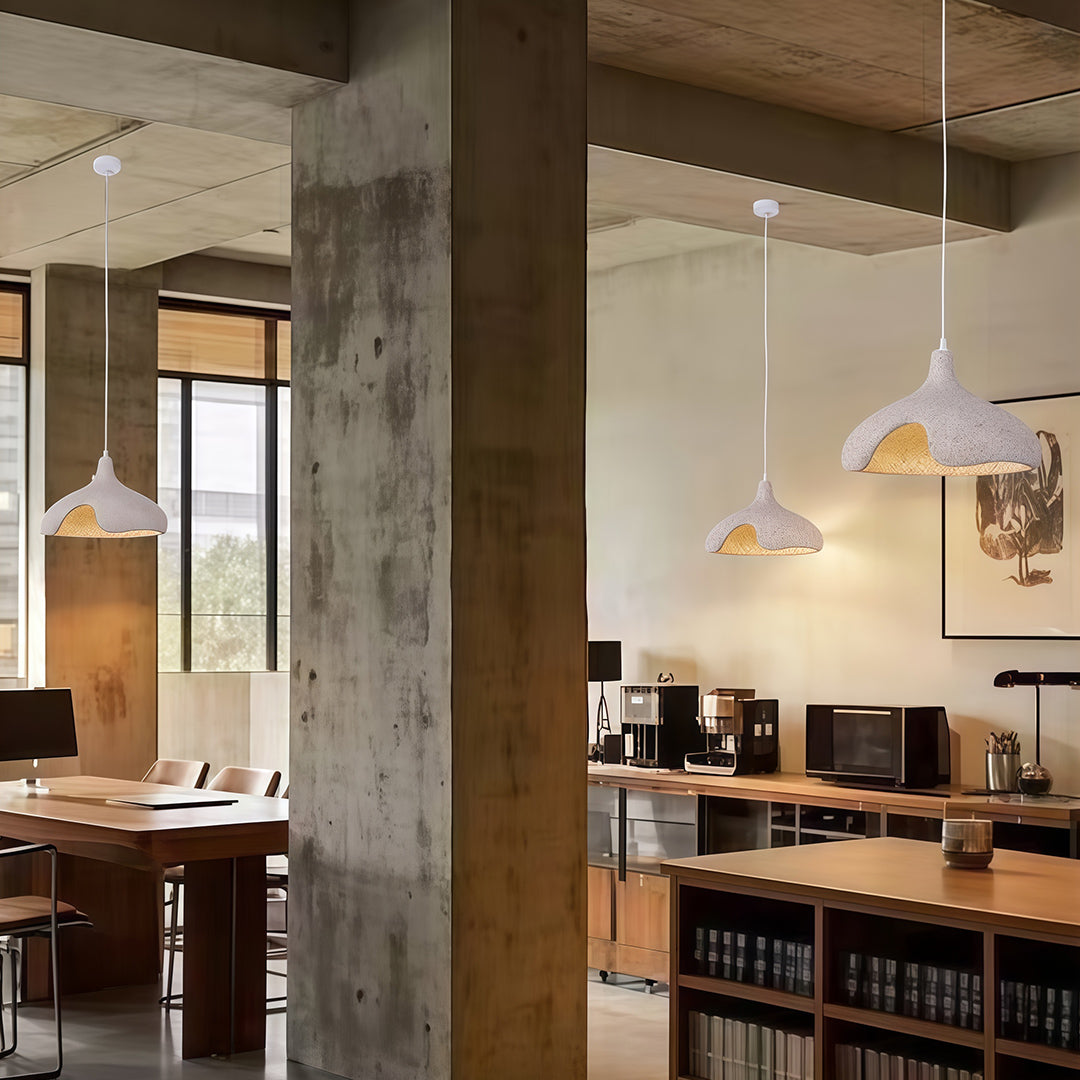 Cement Pendant Lights with organic shapes hanging in contemporary workspace interior.