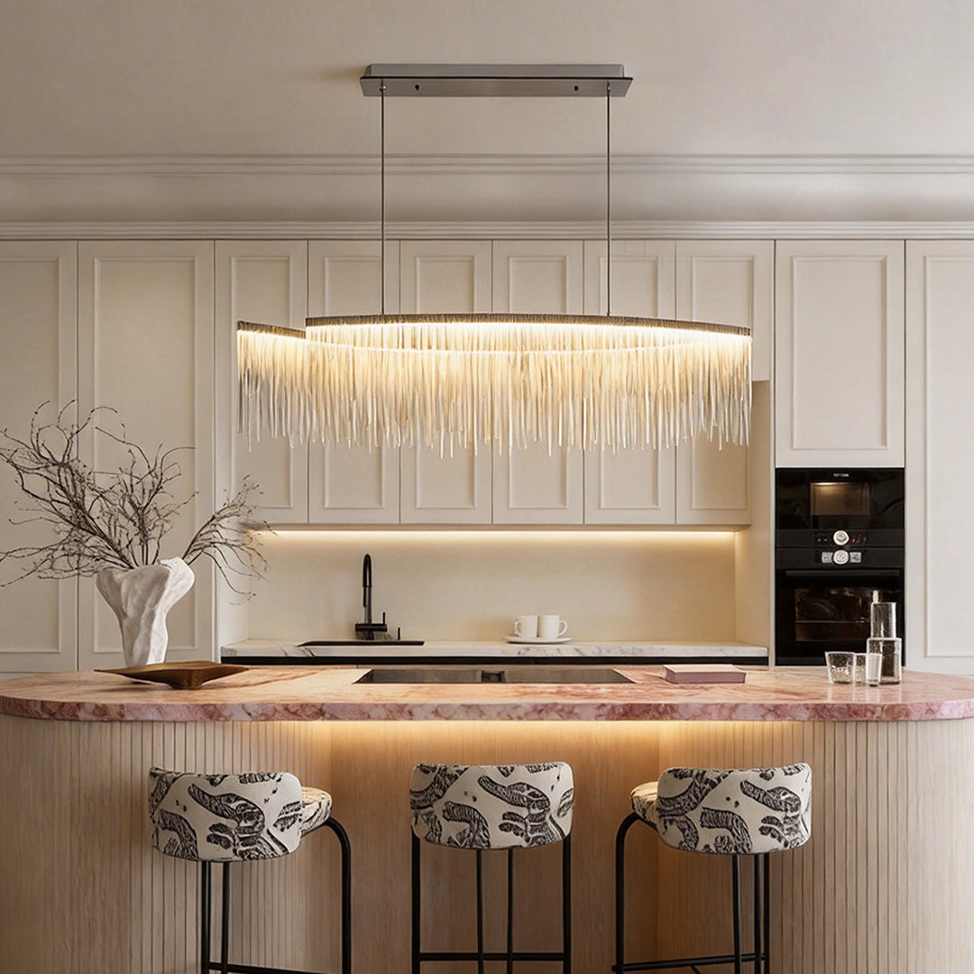 Chain tassel chandelier with a gold finish, providing elegant illumination above a kitchen island.