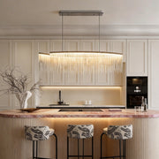 Chain tassel chandelier with a gold finish, providing elegant illumination above a kitchen island.
