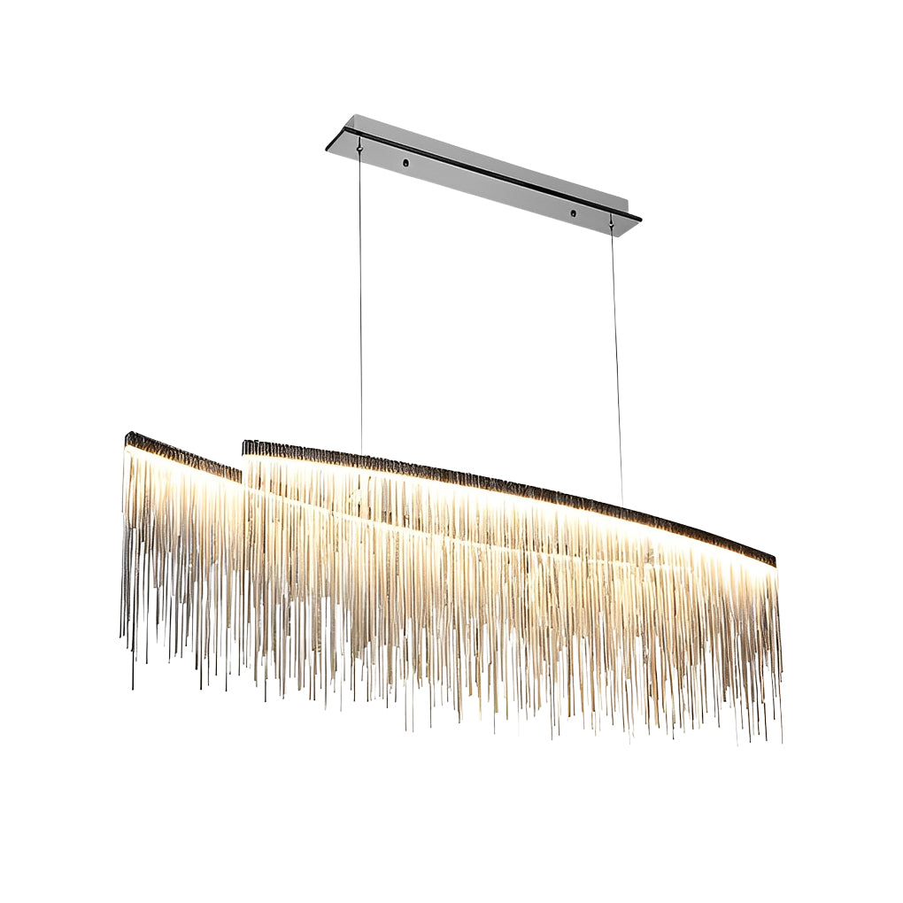 Chain tassel chandelier with a gold finish, providing soft illumination above a table.