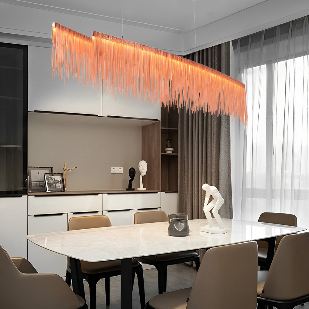 Chain tassel chandelier with a sleek design, illuminating a contemporary dining table.