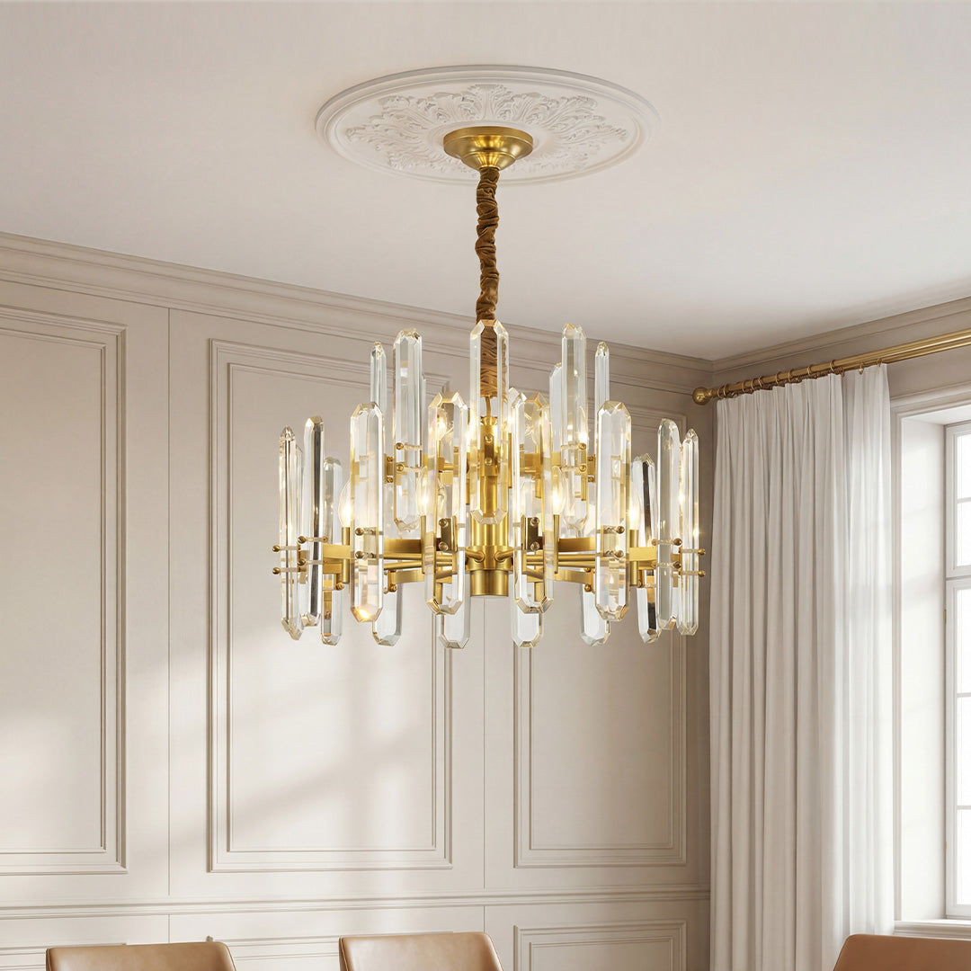 Striking chandelier brass modern design featuring staggered clear crystal prisms and a gold frame suspended from a decorative ceiling medallion.