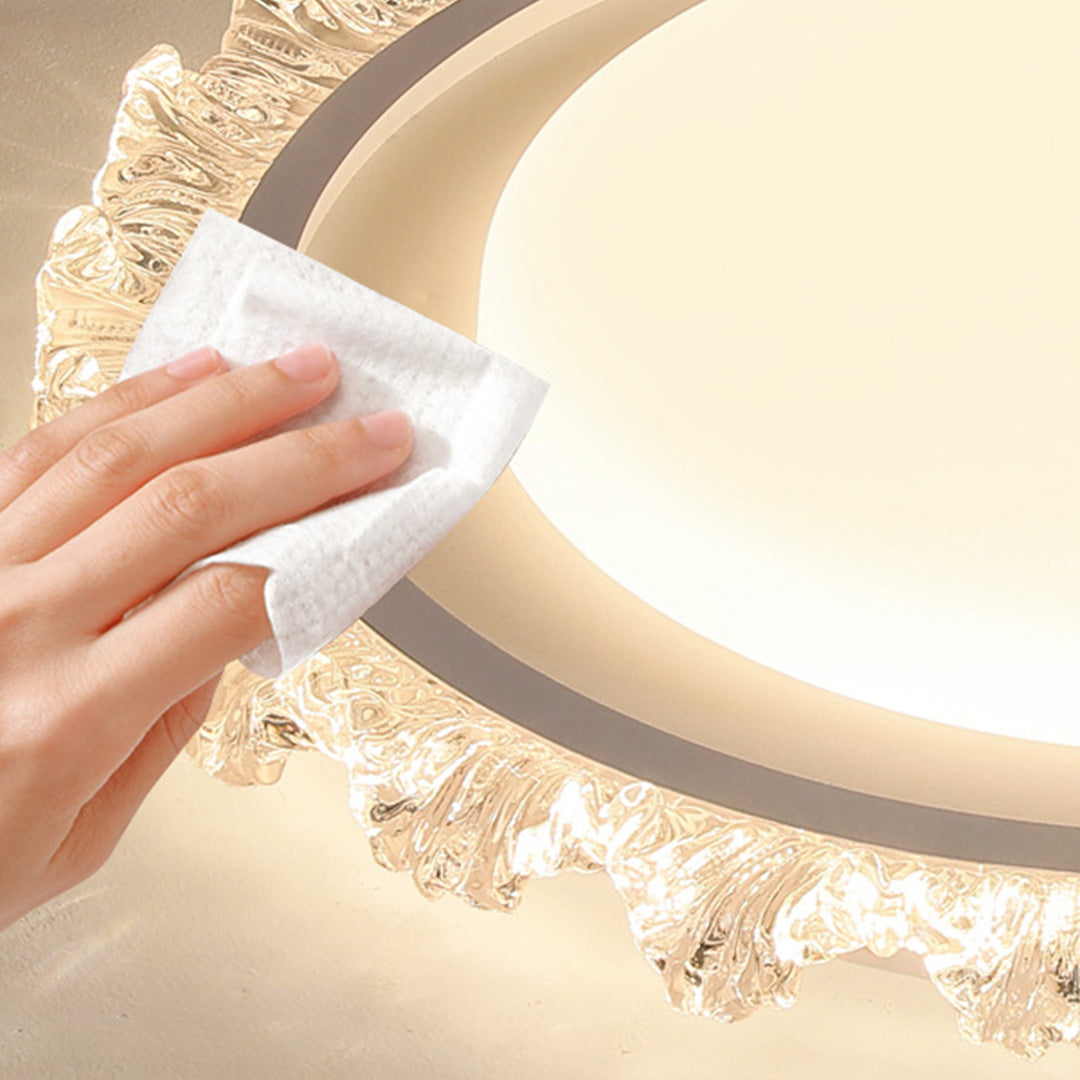 Hand cleaning maintenance of gold glass shade chandelier demonstrating care instructions