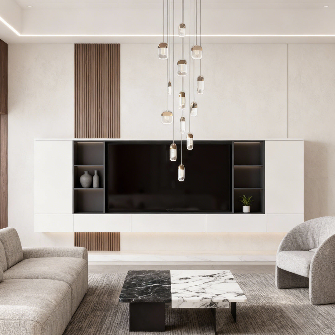 Chandelier for staircase positioned above contemporary living room with black media wall and neutral modern furnishings