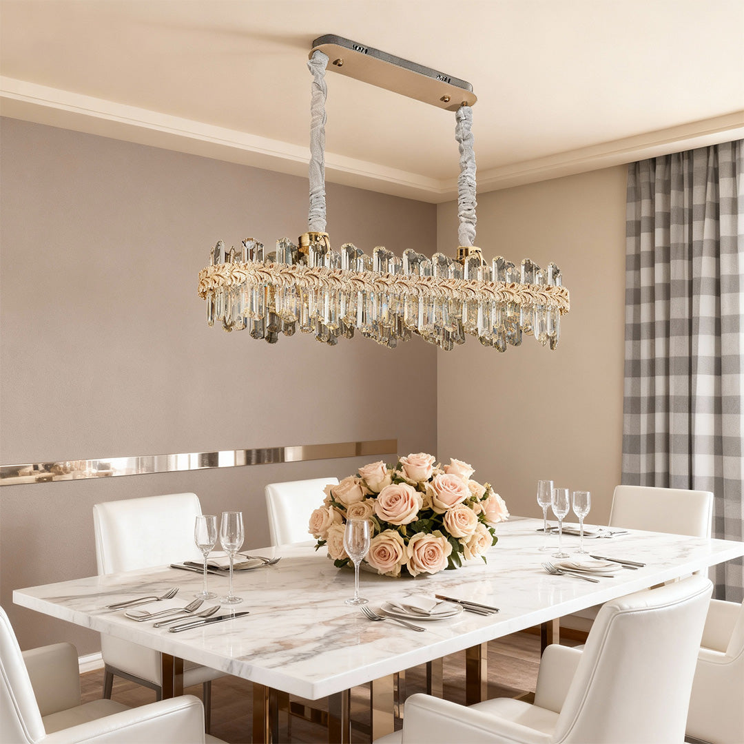 Chandelier lamps crystal with clear crystal prisms and gold finish above the dining table.
