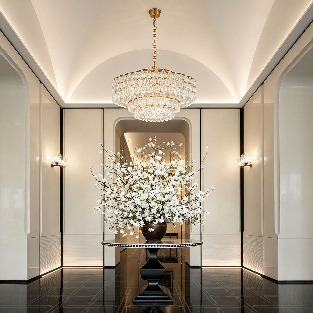 Chandelier lighting crystal centerpiece installed in a sophisticated modern hallway.