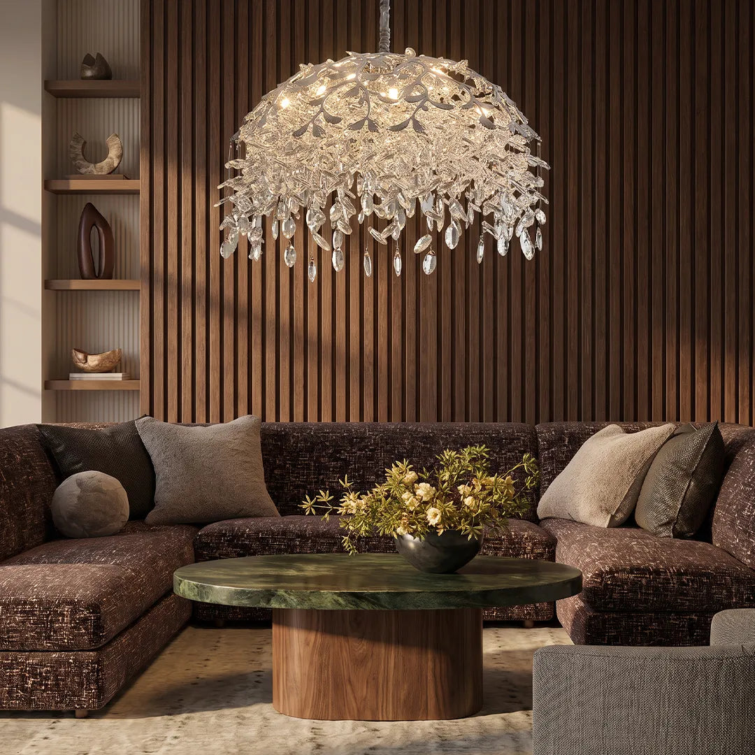 Chandelier with crystal hanging above a modern sectional sofa in a warm living room with a wood slat feature wall.