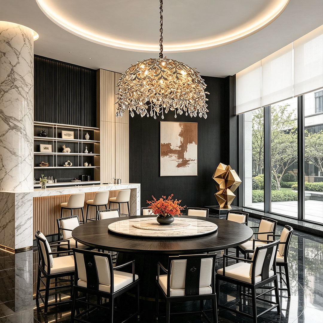 Chandelier with crystal suspended above a round dining table in a refined contemporary dining room.